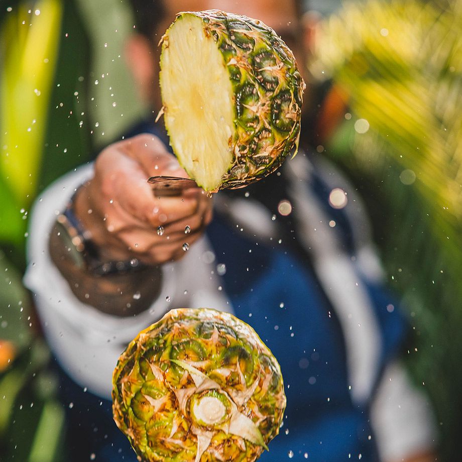 Man Slicing Pineapple